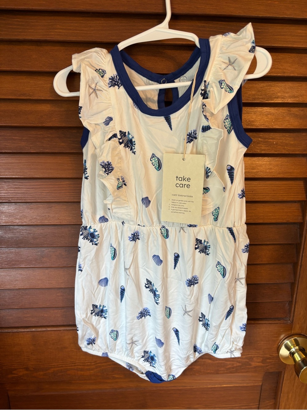 Kyte BABY White Romper with Navy Shell Print
